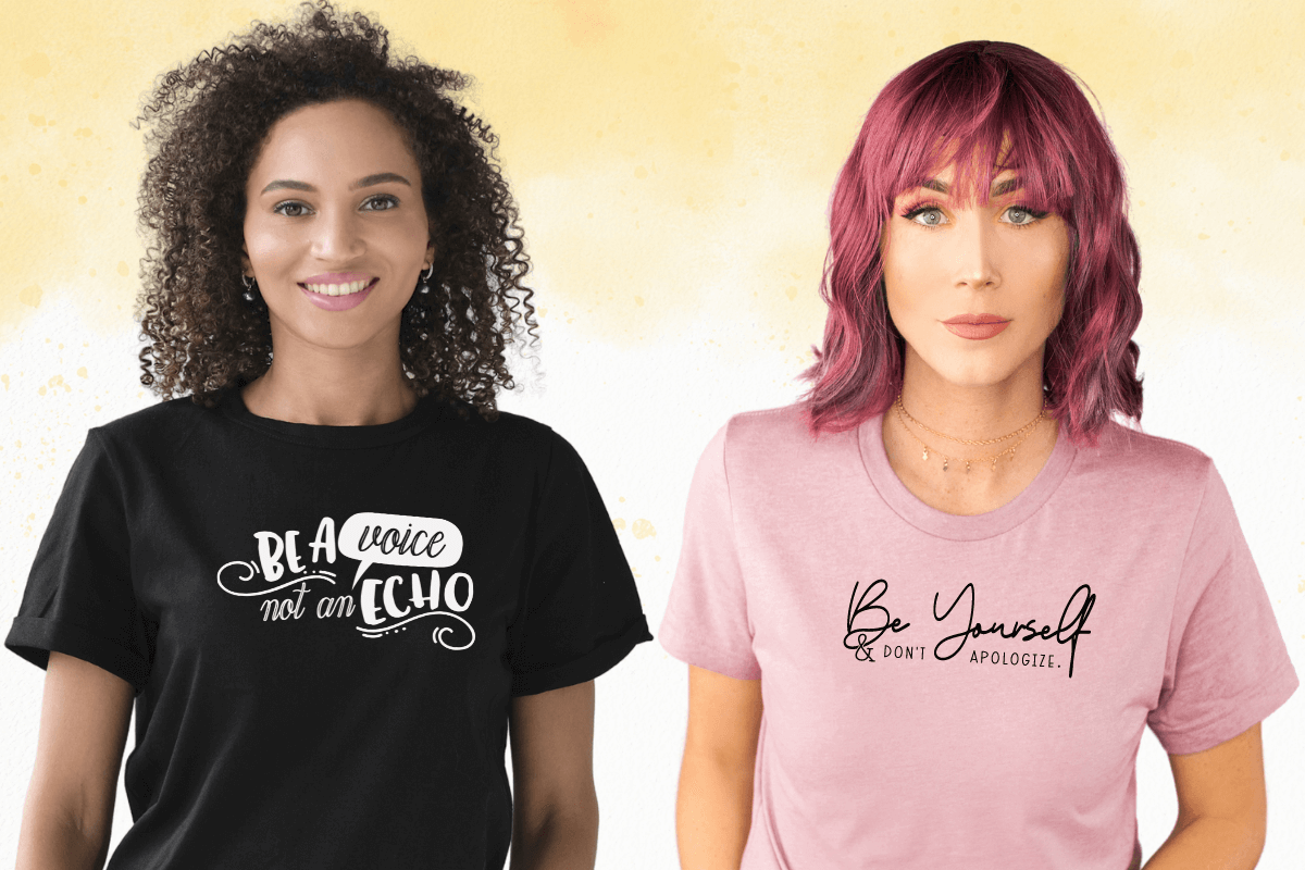 Two women wearing expressive tees. The left one is wearing a black tee with “Be a Voice Not an Echo” in white graphic lettering. The right woman has a Heather Orchid tee with “Be Yourself (in script) and Don’t Apologize” (in serif) black lettering. 