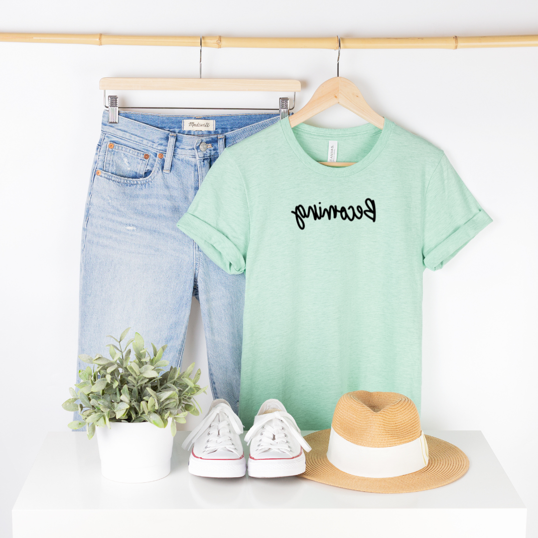 Bella Canvas 3001cvc heather mint t-shirt with Becoming in black script backwards as part of Moxie Momma's Exclusive Reflection line.