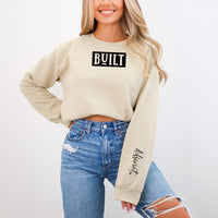 Built on front and different (in script) - both in black HTV on a Gildan 18000 Sand crewneck by Moxie Momma