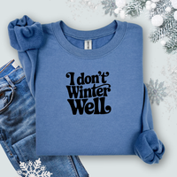 Gildan Indigo Blue sweatshirt with 'I don't winter well' text on a light background with snowflakes and jeans.