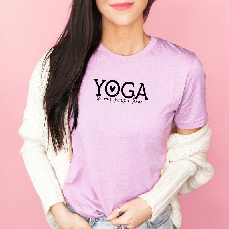 Person wearing a Bella Canvas Heather Prism Lilac t-shirt with 'Yoga is my happy place' text on a pink background