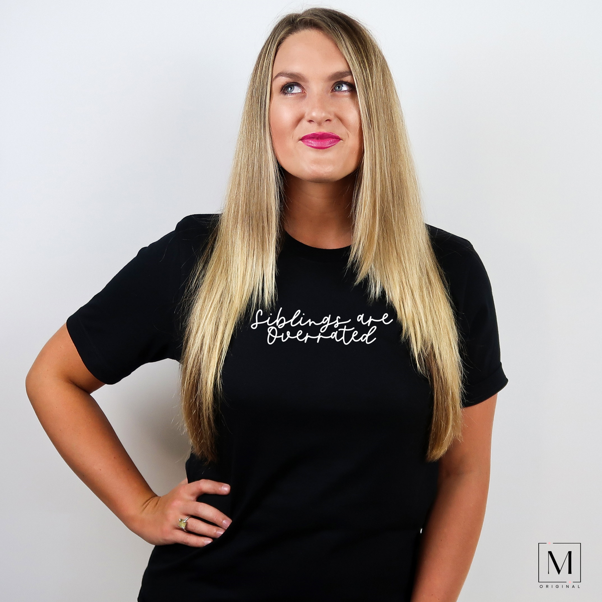 A woman wearing a black heather Bella Canvas 3001cvc t-shirt with white script reading Siblings are overrated. Part of Moxie Momma's exclusive only child line.