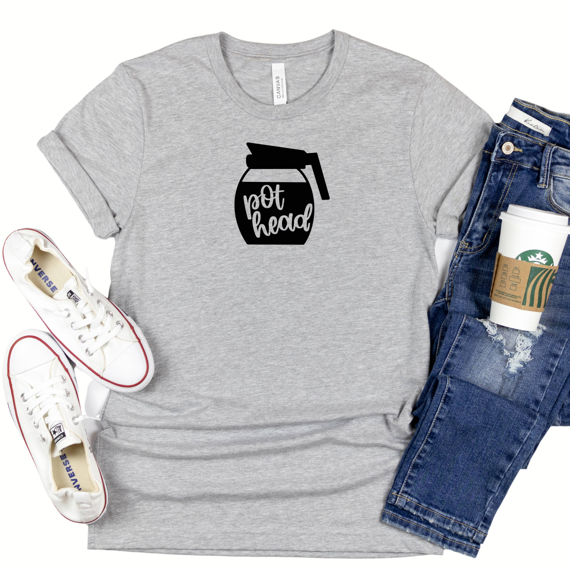 A black coffee pot with pot head in script cut out in the coffee within the pot on an athletic heather 3001cvc Bella Canvas t-shirt.