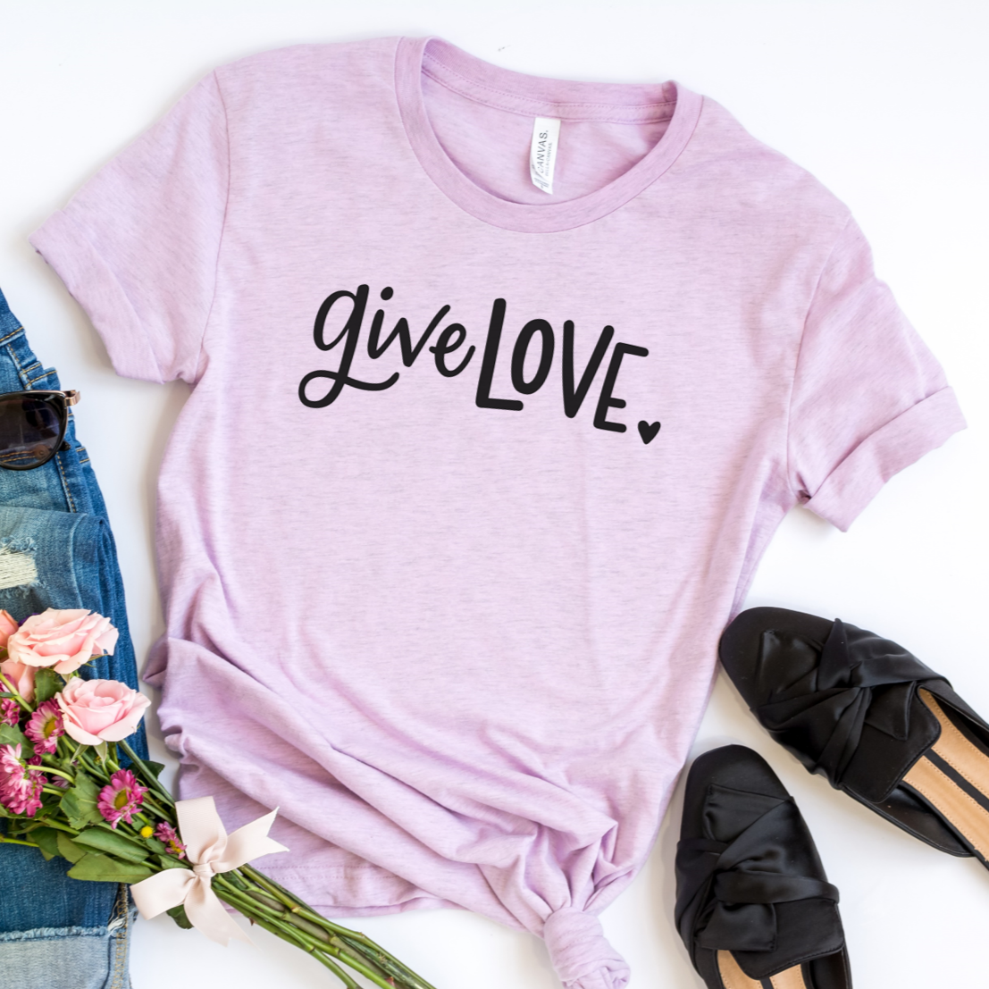 Give love in black on a heather lilac bella canvas 3001cvc t-shirt.