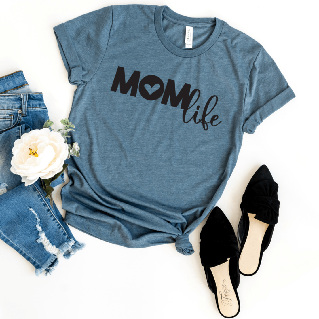 Mom life (Mom all caps with heart for center of O; life in script) in black on a heather deep teal bella canvas 3001cvc t-shirt.