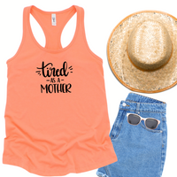 Next Level 1533 light orange racerback tank top with tired as a mother in black text.