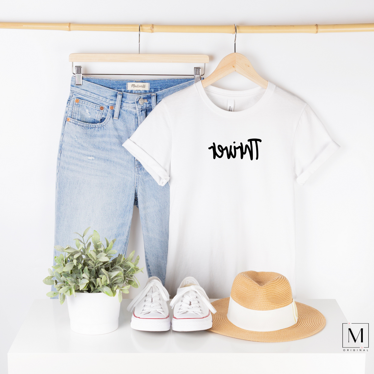 Bella Canvas 3001 white t-shirt with Thriver in black script backwards as part of Moxie Momma's Exclusive Reflection line.